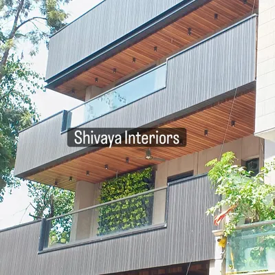 A finished view of a modern residential facade. I balanced the design with dark grey vertical cladding against the natural wood finish of the soffit panels under the balconies, creating depth and visual interest.