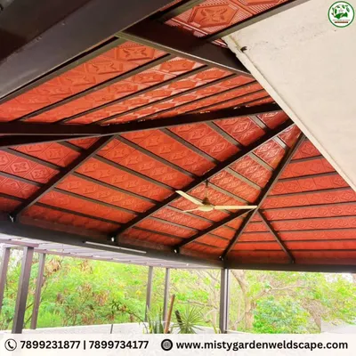 This is the underside of a completed Mangalore tile gazebo roof. The rich red color of the tiles and the sturdy black metal frame create a classic and durable structure, perfect for a shaded outdoor retreat.