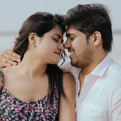 A beautiful close-up on the beach, capturing a moment of pure happiness and connection. The sea breeze and soft light make for a perfect romantic portrait.