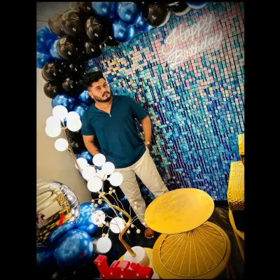 Here I am, the owner of Party Planet, posing in front of one of my custom birthday setups. I started this business to bring a new kind of private celebration space to Hubli.
