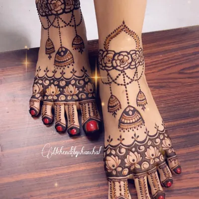 A stunning bridal foot mehendi design with hanging jhumkas and intricate floral patterns, perfect for the bride's big day.