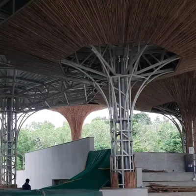 The bamboo parasols at the TAPMI Centre are a testament to our collaborative process. This image shows the intricate steel framework being clad with individual bamboo pieces, a process that combines modern engineering with traditional craftsmanship.
