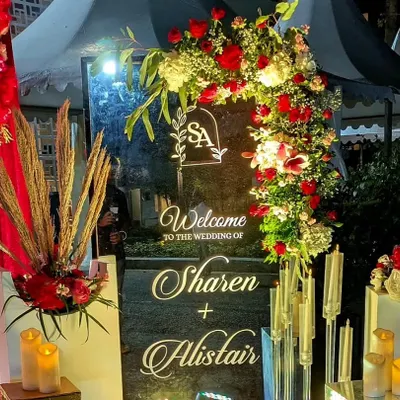 A personalized welcome sign is a beautiful way to greet your guests. For Sharen and Alistair, I designed this elegant mirrored sign with their monogram, framed by red roses and pampas grass.