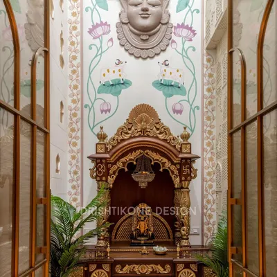 This double-height mandir is the spiritual anchor of the home. We designed it as a grand sanctuary, using a traditional wooden temple, gold-leaf accents, and a hand-painted Shrinath Ji mural to create a space that is both visually stunning and energetically powerful.