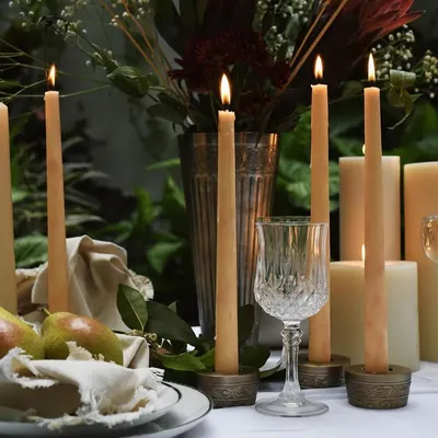 A symphony of candlelight for Byaas Home. This tablescape uses varying heights and the warm glow of multiple candles to create a rich, inviting atmosphere perfect for an intimate gathering.