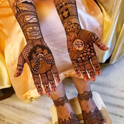 This is a great example of a fully customized bridal mehandi, incorporating the London skyline, couple's initials, an infinity symbol, and beach scenery.