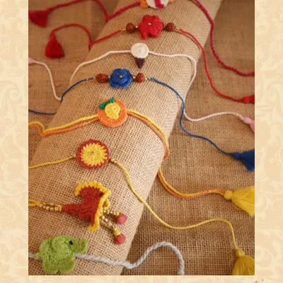 A collection of handmade, 100% cotton rakhis, featuring quirky and colorful crochet designs, perfect for celebrating the sibling bond.