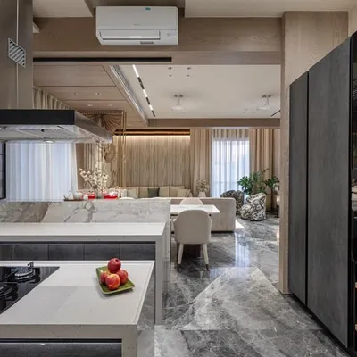 This open-plan kitchen is designed to be the social hub of the house. From the cooking area, you have a clear view of the living room, making it easy to interact with family and guests. The tall ceramic-finish unit houses the oven and provides ample storage.