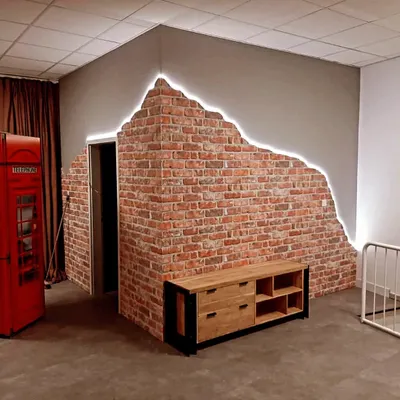 This unique accent wall combines a classic exposed brick texture with a modern "broken plaster" edge, highlighted by an LED strip for a dramatic effect.