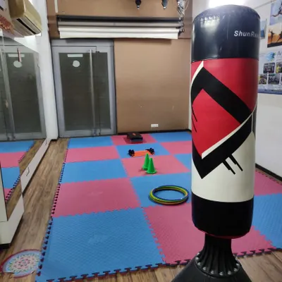 A view of my training academy, ready for a session. The matted floors provide a safe surface for practicing throws and ground techniques, while equipment like cones and rings are used for agility and coordination drills.