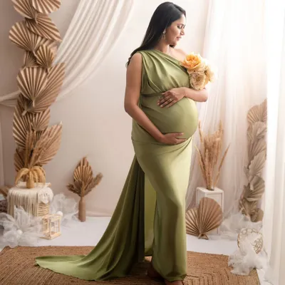 This full-length portrait showcases a beautiful olive green gown against my boho-inspired set, featuring dried palm leaves, a jute rug, and soft, natural light.