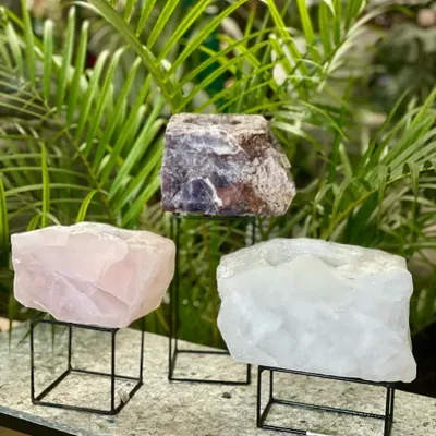 These are our crystal planters, available in rose quartz, white quartz, and amethyst. These natural formations are believed to increase good energy and make a wonderful gift.