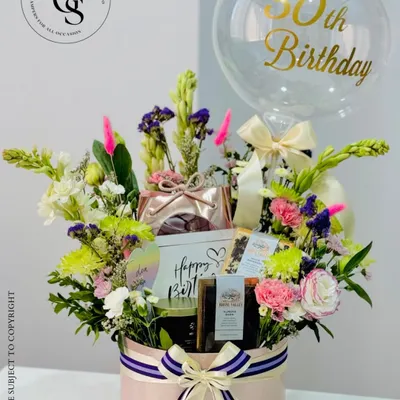 A spectacular 30th birthday hamper designed to wow. This large pink hatbox is overflowing with fresh flowers, curated gifts, and a personalized balloon, making it the ultimate celebratory statement piece.
