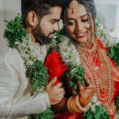 A close, intimate portrait of a South Indian couple, adorned with traditional garlands. I focus on capturing the loving glances and gentle smiles.