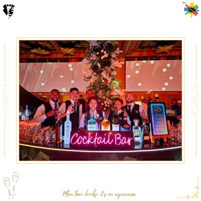 Our team behind a neon-lit "Cocktail Bar" at a grand wedding reception. We are equipped to handle large-scale celebrations with professionalism and style.