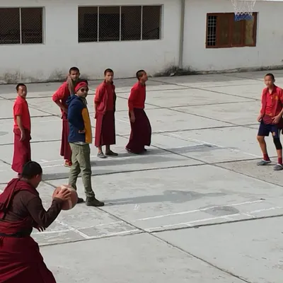 Basketball has no boundaries. This impromptu coaching session during a monastery visit was a truly special experience, sharing the fundamentals of the game with a group of enthusiastic young monks.