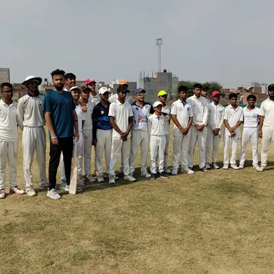 A group of our young cricketers standing with their coach. We foster a strong sense of team and mentorship, creating an environment where players feel guided and supported.