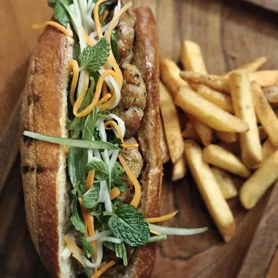Inspired by my travels in Vietnam, our Bánh Mì is all about harmony. A crispy baguette is filled with freshly grilled pork patties, pickled vegetables, and fresh herbs. It's available exclusively on our limited edition brunch menu.