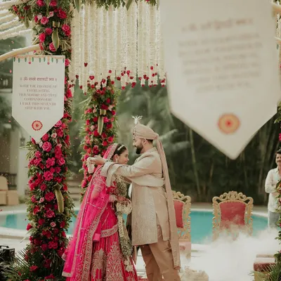 The moment of union during the Varmala ceremony. I captured the groom placing the garland on his bride, with smoke effects adding a touch of magic to this sacred tradition.