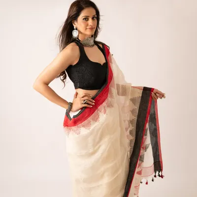 A saree is a story woven in six yards of grace. This image from a brand shoot for a saree company showcases the elegant drape and intricate details of the fabric.