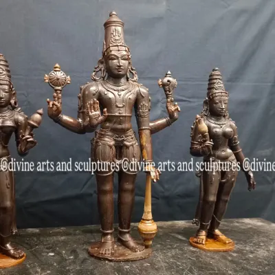 A custom wax model of Lord Ranganathar accompanied by his divine consorts, Sridevi and Bhoodevi. The intricate details of their crowns and postures are carefully shaped by hand at this stage.