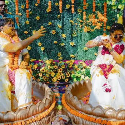 Pure, unadulterated fun during a South Indian Haldi ceremony. The couple's playful antics and sunglasses add a modern twist to the tradition.