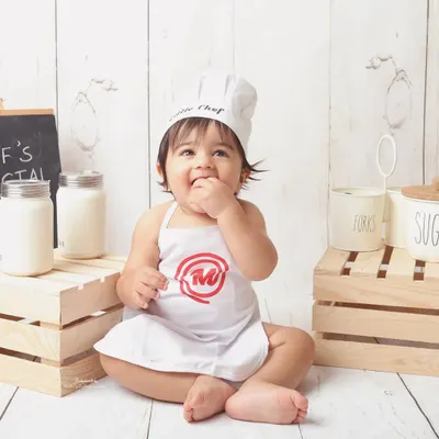 Meet the little chef. This themed shoot is one of my most popular, and it's easy to see why. The tiny apron, chef's hat, and kitchen-themed props create an unbelievably cute and memorable scene.