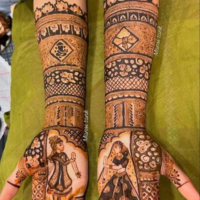 A complete bridal design featuring bride and groom figures on the palms. The arms are decorated with auspicious symbols like the swastika and Ganesha, along with floral patterns.