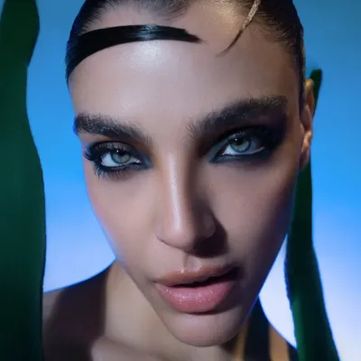 An extreme close-up from a high-fashion beauty shoot. The focus is on the intense, smoky eye makeup and flawless skin, demonstrating my skill in capturing detailed beauty work.
