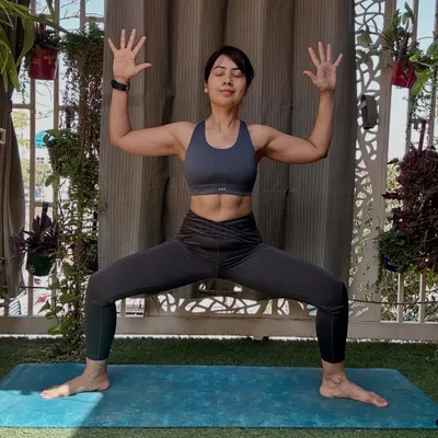 The Goddess Pose, or Utkata Konasana, is a powerful stance for building lower body and core strength. As you can see from my defined core, this pose engages the entire midsection. It grounds your energy, fires up your inner thighs and glutes, and opens the hips.