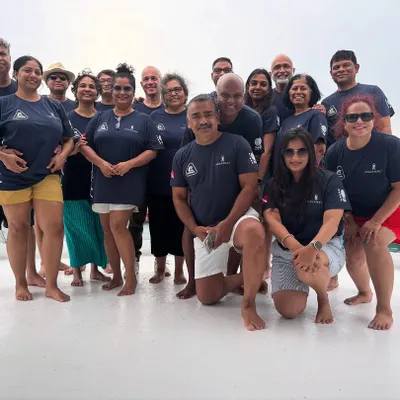 The Catholic Club crew, all smiles on the deck of our liveaboard in the Maldives. Even when the weather wasn't perfect, their amazing spirit made the trip unforgettable.