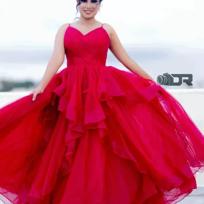 This stunning red ballgown is one of my signature pieces. The layered tulle skirt and fitted bodice create a classic princess silhouette, perfect for making a grand entrance.