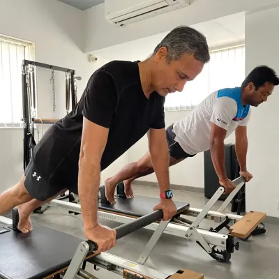 Elite athletes like Leander Paes trust our methods for peak performance and recovery. Here, he demonstrates a plank on the Pilates reformer, an exercise that builds incredible core strength and stability, essential for any sport.