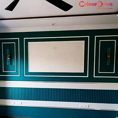 An elegant living room wall featuring a deep teal paint complemented by crisp white beading. We expertly paint both walls and MDF or solid wood beading to create a sophisticated, layered look with a perfect, professional finish.