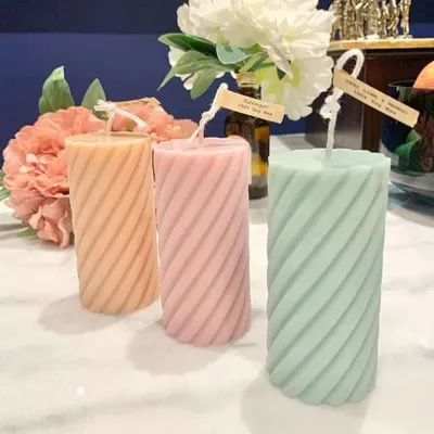My spiral pillar candles in soft pastel shades. These are a great way to add a touch of modern elegance and color to your living room or bedroom decor.