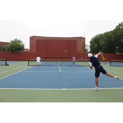A player unleashes a powerful forehand during a match on our courts. The high-quality playing surface and professional setup are ideal for competitive tennis tournaments.