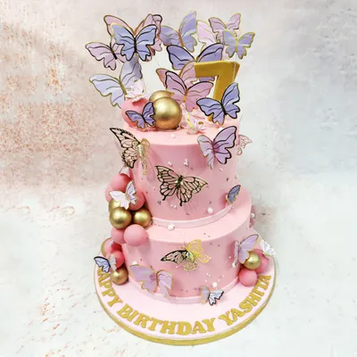 This two-tiered Pink Cake With Butterflies is a whimsical dream, with a cascade of lilac and gold butterflies fluttering around the soft pink tiers.