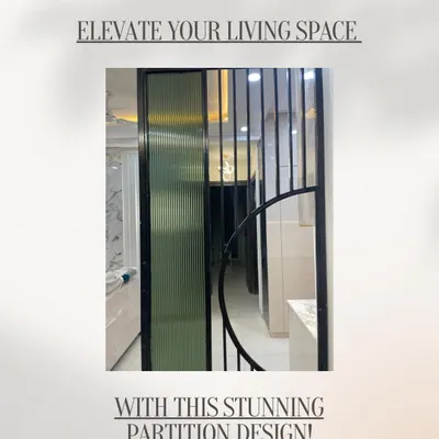 Elevate your living space with a stunning partition. This design uses a combination of fluted glass and black metal slats to create a stylish separation without closing off the room.