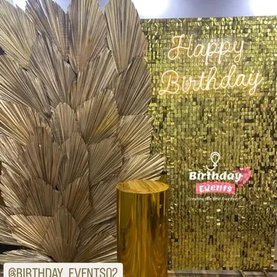 This trendy photo booth combines a gold sequin wall with dry palm decor for a boho-glam vibe. We can add a custom neon sign like this "Happy Birthday" one for any pre-wedding event like a bridal shower or sangeet.