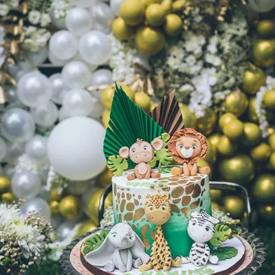 This adorable jungle-themed cake was the centerpiece for an elegant cradle ceremony. The cute fondant animals contrast beautifully with the sophisticated white and gold balloon wall in the background, showing how I can blend themes.
