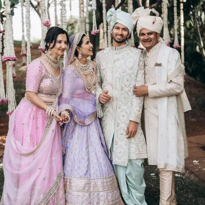 A beautiful family portrait with the couple and their parents. I aim for natural, happy expressions that truly reflect the family's joy on this special day.