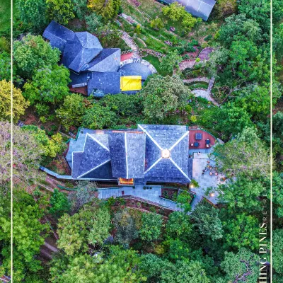 An aerial perspective of our Blushing Pines Retreat in Bhowali, showing how the multi-level structures are nestled into the hillside to maximize views and minimize environmental impact.