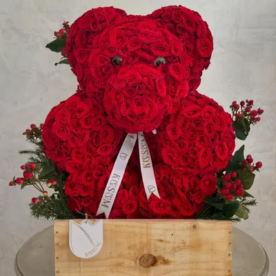 This floral teddy bear is meticulously crafted from hundreds of individual red roses. It's a popular choice for romantic occasions and proposals, offering a unique and sculptural alternative to a traditional bouquet.