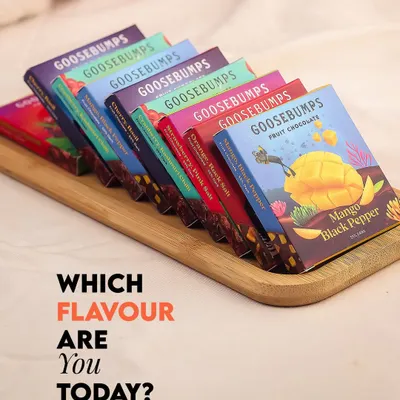 Here is our complete lineup of fruit and spice infused chocolates. We've arranged them to showcase the vibrant, story-driven packaging for each of our five unique flavour combinations, from Mango & Black Pepper to Cherry & Basil.