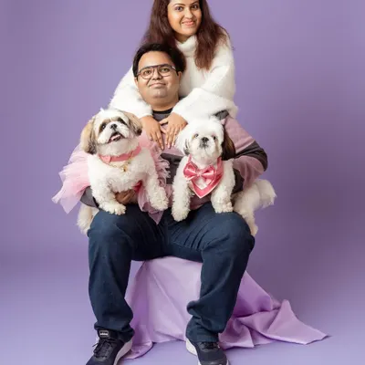 This family portrait is so full of personality! The coordinating purple and white outfits against the lavender backdrop create a beautiful, cohesive look. It shows how a little planning can lead to a stunning studio result.