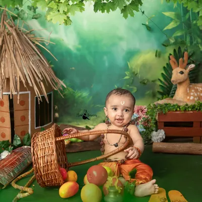 A joyful little Lord Ram playing with a basket of fruits during our Ram Navami themed shoot. The set includes a handmade hut and a forest backdrop to recreate the story.
