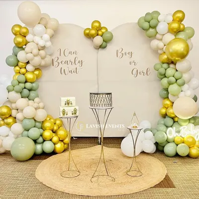 "I Can Bearly Wait!" A sweet teddy bear themed gender reveal party. The soft green, gold, and cream balloons create a neutral and elegant look for the "Boy or Girl?" surprise.