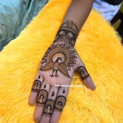 A unique and traditional design featuring a bird with widespread wings on the palm, with portrait details on the fingertips.