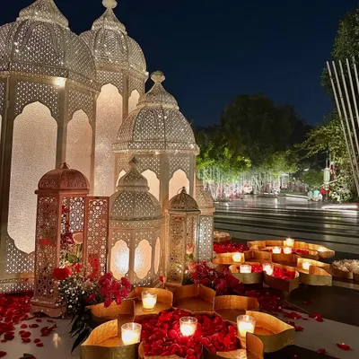 Our signature Moroccan decor. Here, grand white lanterns are combined with beds of red roses and candles, creating a bold and beautiful entrance.