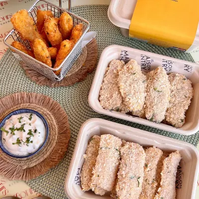 My cook-and-serve fish fingers, shown both ready-to-fry and golden-brown after cooking. They come with a delicious tartare dip, making for a quick and easy gourmet snack you can prepare at home.